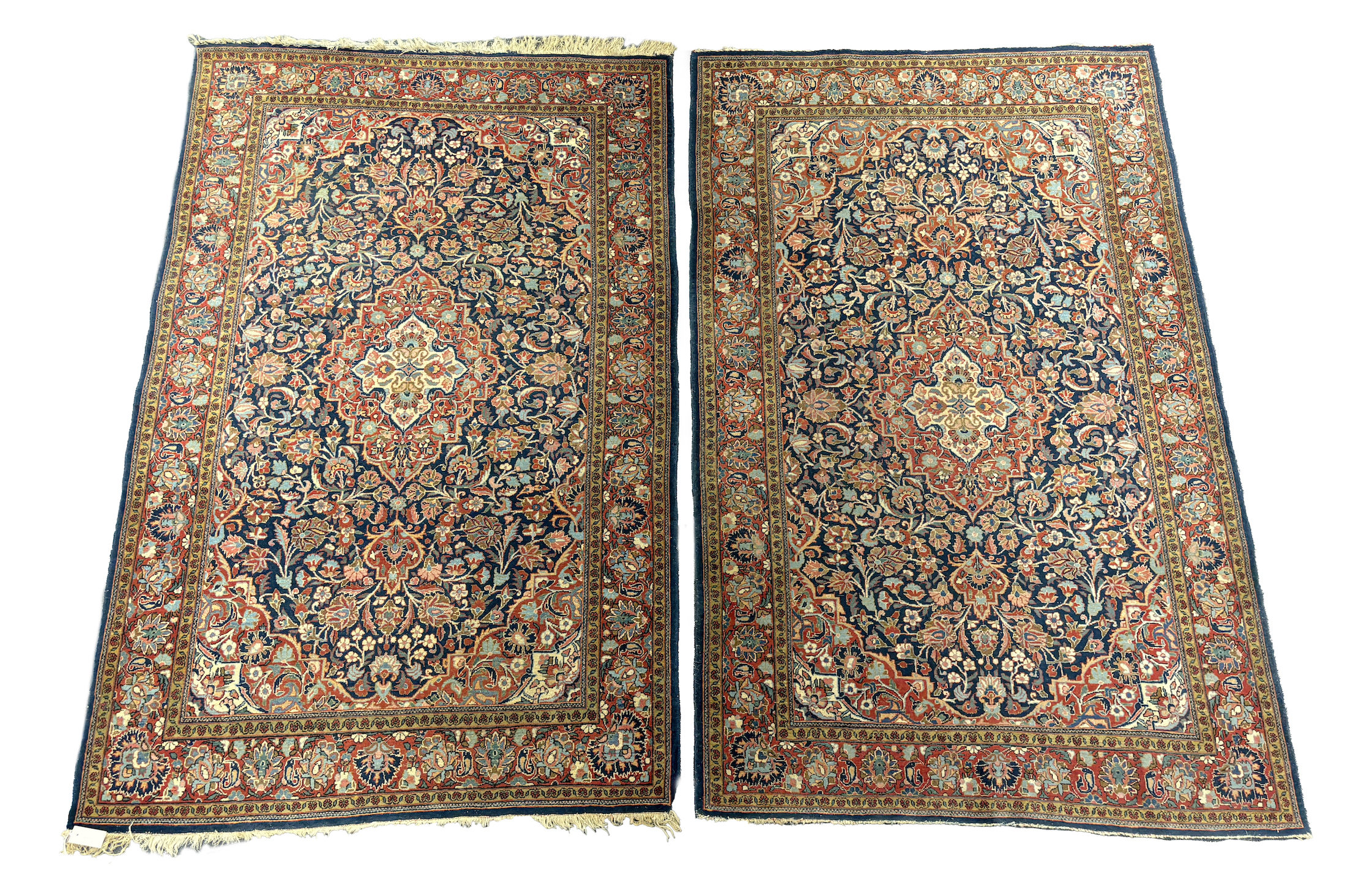 A pair of Kashan blue ground rugs, 216 x 139cm